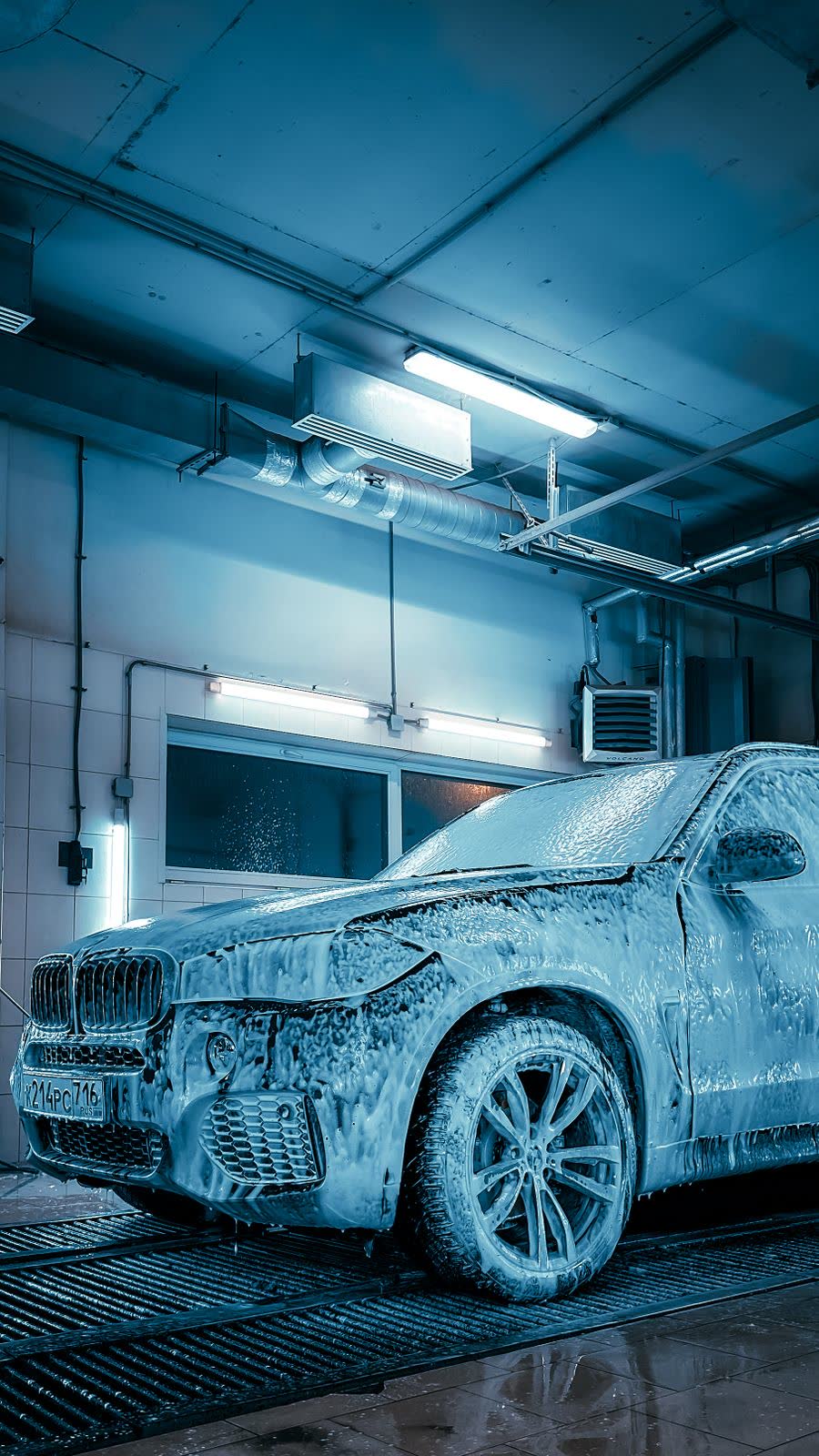 SUV covered in foam during a full clean